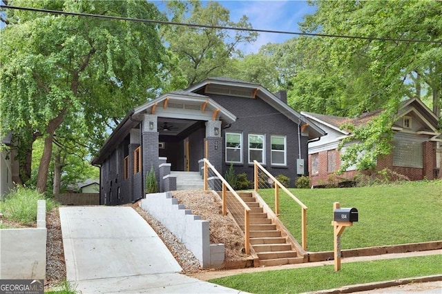 994 Byron Dr SW, Atlanta, GA 30310 - bungalow-style home featuring a front yard, a ceiling fan, brick siding, and stairway