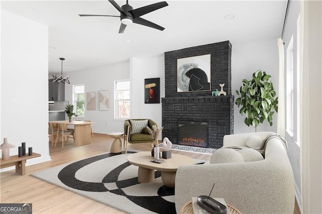 994 Byron Dr SW, Atlanta, GA 30310 - living room with wood finished floors, a fireplace, a ceiling fan, baseboards, and recessed lighting