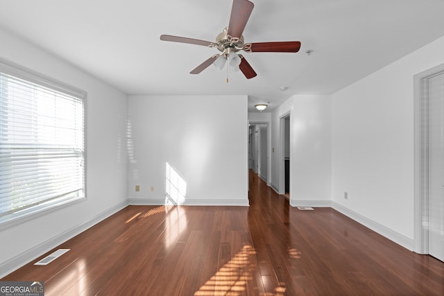 1102 Madison Ln SE, Smyrna, GA 30080 - unfurnished living room featuring a ceiling fan, wood finished floors, and baseboards