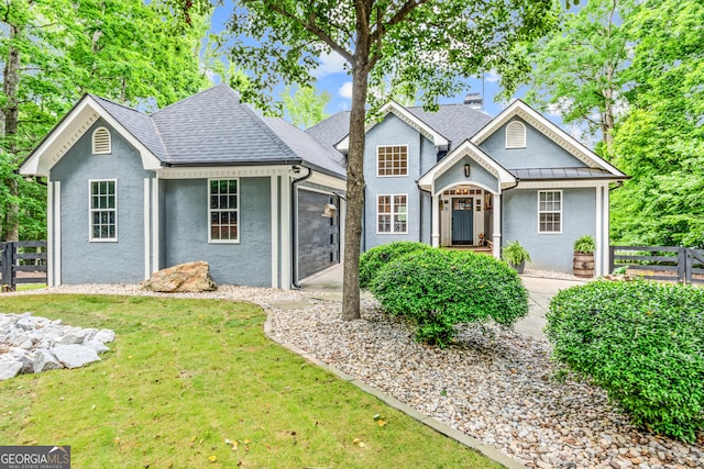 view of front of property featuring stucco siding and a shingled roof