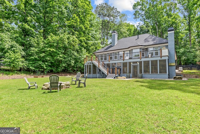 back of property with a sunroom, stairway, a chimney, and a balcony