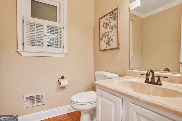 half bath with toilet, ornamental molding, tile patterned floors, vanity, and baseboards