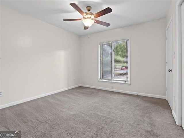 unfurnished bedroom featuring carpet floors, baseboards, and a ceiling fan