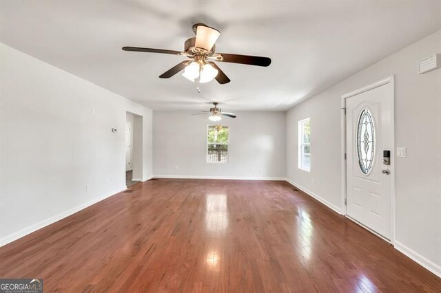 entryway with ceiling fan, wood finished floors, and baseboards