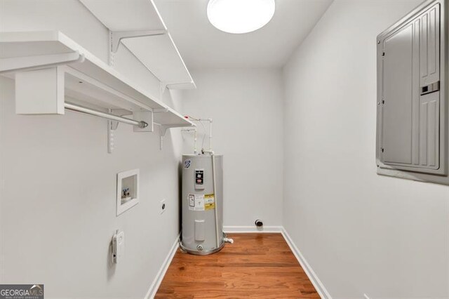 laundry area with water heater, electric panel, hookup for an electric dryer, hookup for a washing machine, and wood finished floors