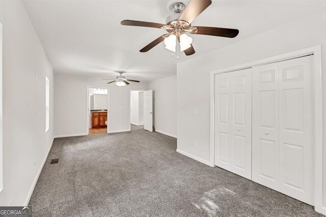 unfurnished living room with a ceiling fan, carpet flooring, and baseboards