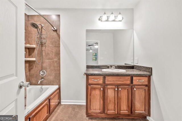 bathroom featuring vanity, ceiling fan, tile patterned flooring, shower / bathtub combination, and baseboards