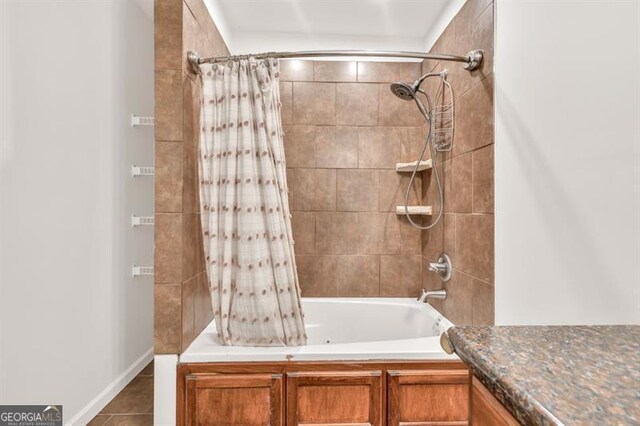 full bathroom with shower / bathtub combination with curtain, tile patterned floors, and vanity