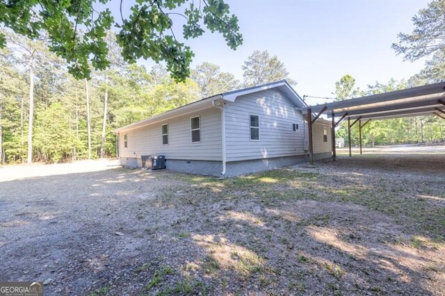 view of home's exterior with a carport and cooling unit