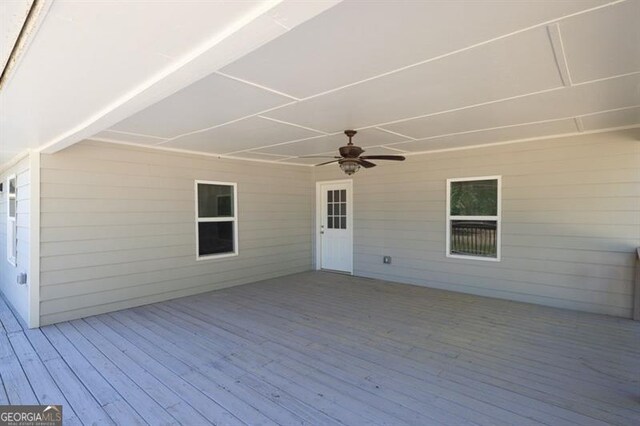 view of vehicle parking with a storage shed, a detached garage, and a carport