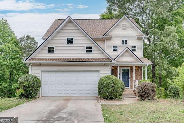 traditional-style home with driveway, covered porch, and a shingled roof