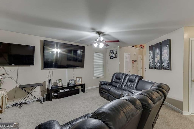 living area with carpet flooring, baseboards, and ceiling fan