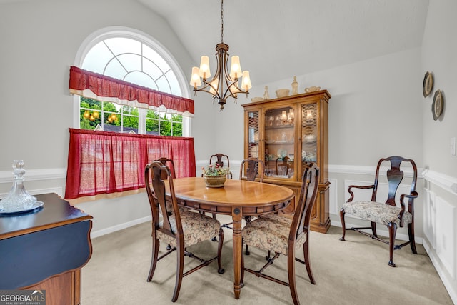 dining space with vaulted ceiling, a chandelier, and light carpet