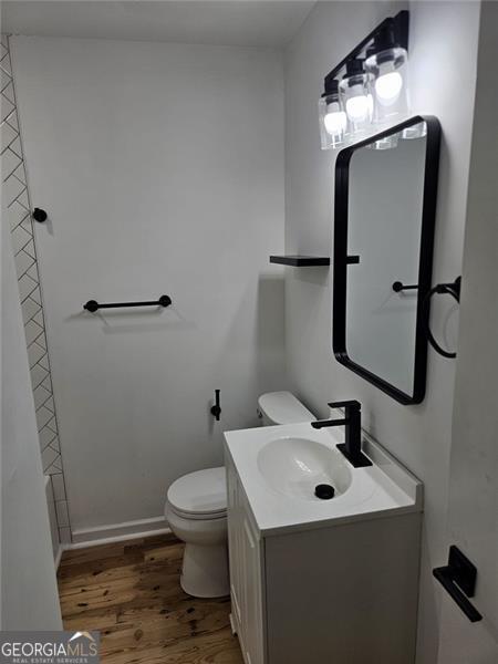 775 Lee Andrews Ave, Atlanta, GA 30315 - bathroom featuring wood finished floors, toilet, and vanity