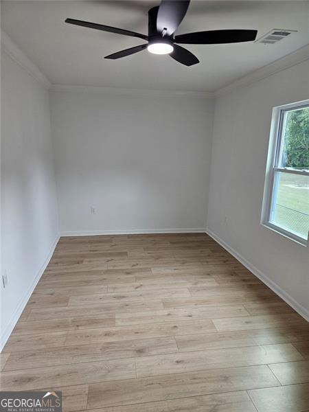 775 Lee Andrews Ave, Atlanta, GA 30315 - empty room featuring ceiling fan, ornamental molding, light wood-type flooring, and baseboards