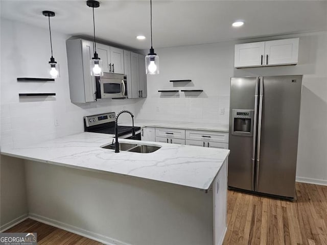 775 Lee Andrews Ave, Atlanta, GA 30315 - kitchen with appliances with stainless steel finishes, a peninsula, a sink, light stone counters, and recessed lighting