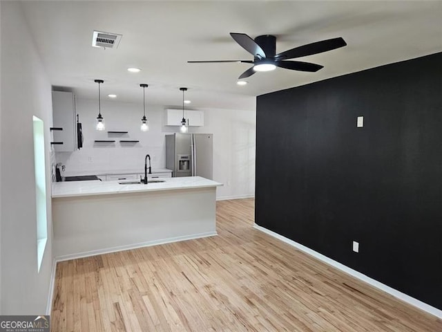 775 Lee Andrews Ave, Atlanta, GA 30315 - kitchen featuring stainless steel fridge, a sink, a ceiling fan, open shelves, and light countertops