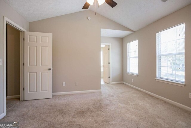 4812 Browns Mill Ferry Rd, Lithonia, GA 30038 - unfurnished bedroom with carpet flooring, vaulted ceiling, baseboards, connected bathroom, and a ceiling fan