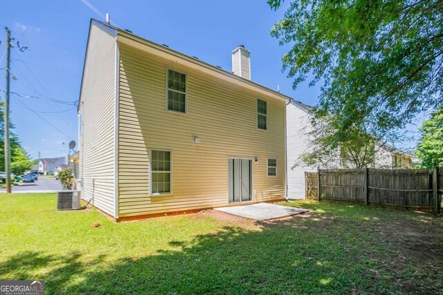 4812 Browns Mill Ferry Rd, Lithonia, GA 30038 - back of property with a patio area, a chimney, and central air condition unit