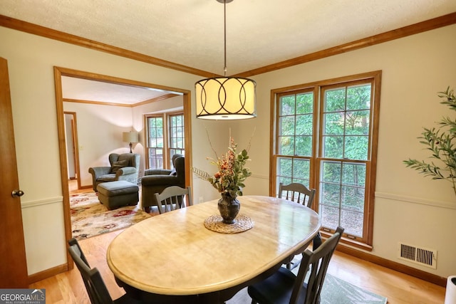 3311 Creek Hollow Dr, Marietta, GA 30062 - dining space with healthy amount of natural light, light wood finished floors, ornamental molding, and a textured ceiling