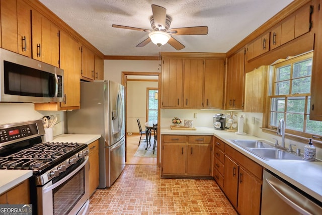 3311 Creek Hollow Dr, Marietta, GA 30062 - kitchen with appliances with stainless steel finishes, light countertops, brick patterned flooring, a ceiling fan, and brown cabinets