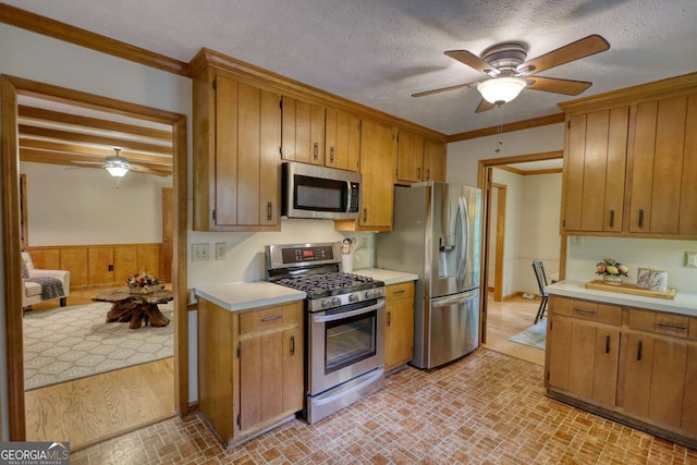 3311 Creek Hollow Dr, Marietta, GA 30062 - kitchen with stainless steel appliances, ceiling fan, light countertops, brick patterned flooring, and ornamental molding