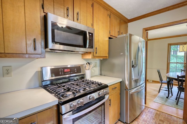 3311 Creek Hollow Dr, Marietta, GA 30062 - kitchen featuring stainless steel appliances, ornamental molding, light countertops, and brown cabinets