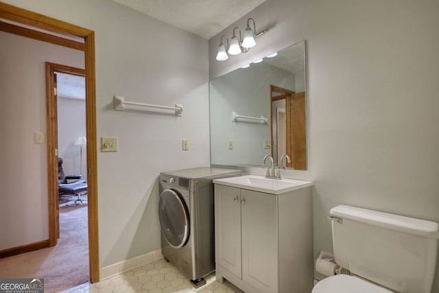 3311 Creek Hollow Dr, Marietta, GA 30062 - bathroom featuring washer / clothes dryer, vanity, and tile patterned flooring