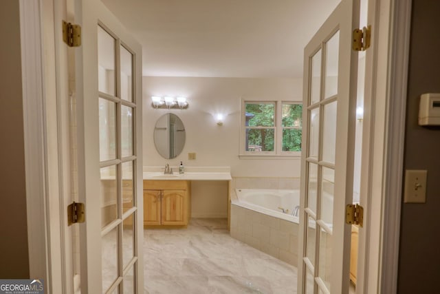 3311 Creek Hollow Dr, Marietta, GA 30062 - bathroom featuring french doors, vanity, a bath, and marble look tiles