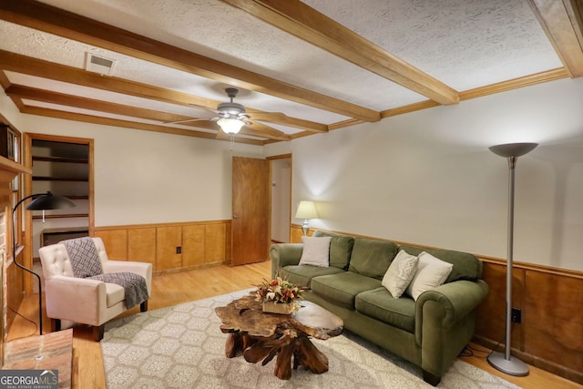 3311 Creek Hollow Dr, Marietta, GA 30062 - living room featuring beamed ceiling, a wainscoted wall, a ceiling fan, wood finished floors, and wooden walls
