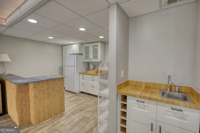 3311 Creek Hollow Dr, Marietta, GA 30062 - kitchen featuring freestanding refrigerator, light wood-type flooring, recessed lighting, white cabinets, and glass insert cabinets