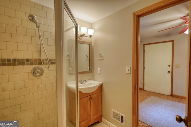3311 Creek Hollow Dr, Marietta, GA 30062 - bathroom featuring a tile shower, vanity, and ceiling fan