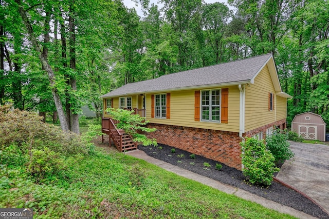 3311 Creek Hollow Dr, Marietta, GA 30062 - single story home featuring a storage shed, brick siding, asphalt driveway, stairs, and a wooden deck