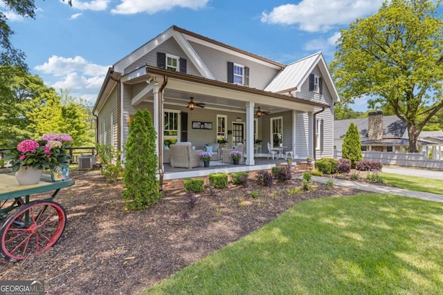view of front of home with covered porch, a ceiling fan, and central AC