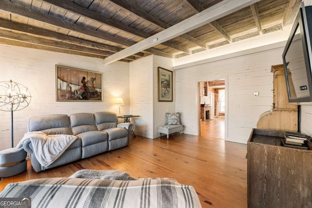 living room with wood finished floors, wooden ceiling, and beamed ceiling