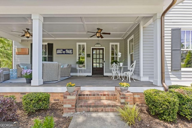 entrance to property with covered porch and a ceiling fan