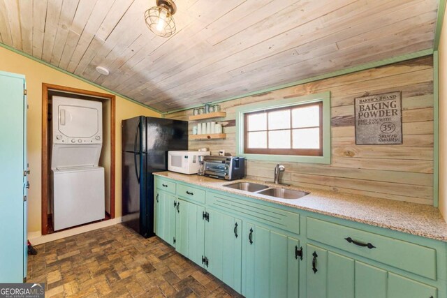 kitchen featuring a sink, stacked washer and clothes dryer, white microwave, wood ceiling, and vaulted ceiling