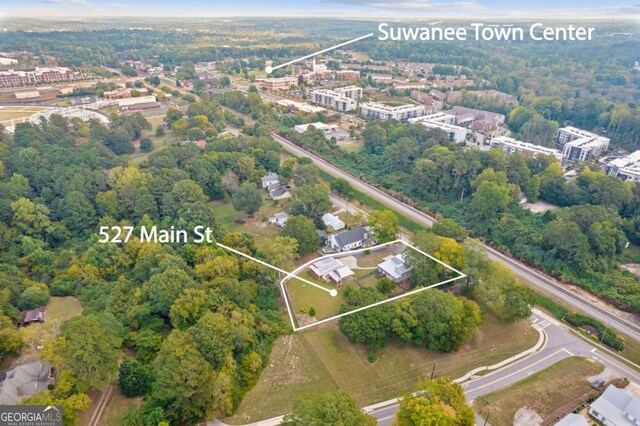 aerial view of property and surrounding area featuring property parcel outlined