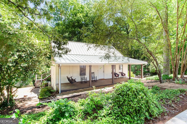 1700 Jimmy Daniel Rd, Watkinsville, GA 30677 - rear view of property featuring a standing seam roof, covered porch, metal roof, and stairway