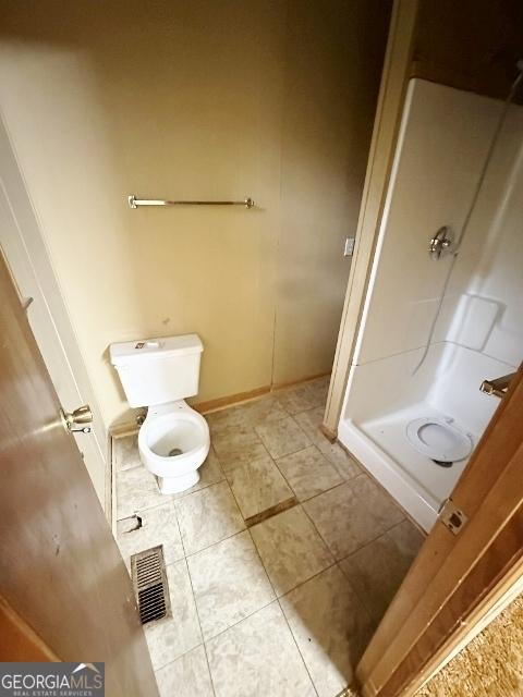 310 Advantage Ln, Swainsboro, GA 30401 - full bathroom featuring a stall shower, toilet, and tile patterned floors