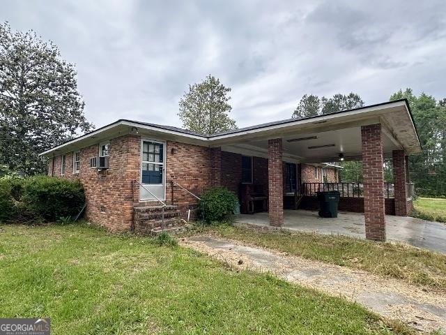 310 Advantage Ln, Swainsboro, GA 30401 - view of front of property with a front yard, brick siding, a patio, and entry steps