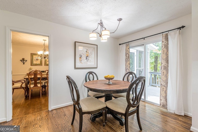 4314 Arbor Bridge Ct, Marietta, GA 30066 - dining room featuring a chandelier, light wood finished floors, and a textured ceiling