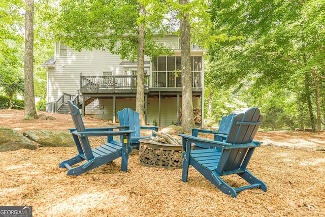 4314 Arbor Bridge Ct, Marietta, GA 30066 - rear view of property featuring an outdoor fire pit, stairway, a wooden deck, and a sunroom