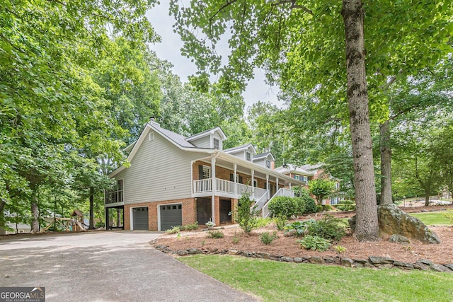 4314 Arbor Bridge Ct, Marietta, GA 30066 - view of front of home with a porch, a garage, brick siding, stairs, and driveway