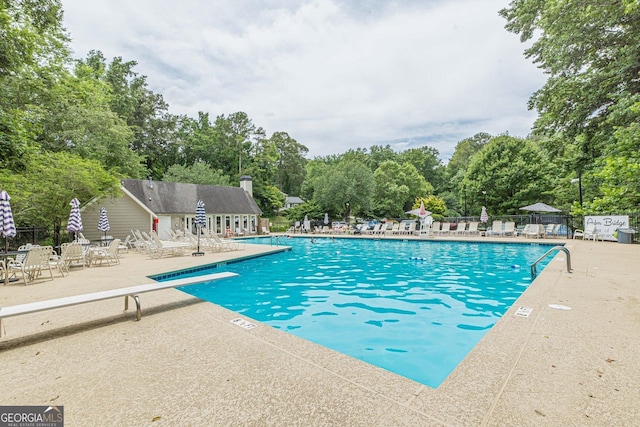 4314 Arbor Bridge Ct, Marietta, GA 30066 - community pool with a patio area, a diving board, and view of wooded area