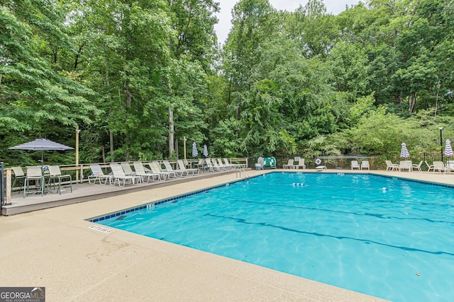 4314 Arbor Bridge Ct, Marietta, GA 30066 - community pool with view of wooded area and a patio