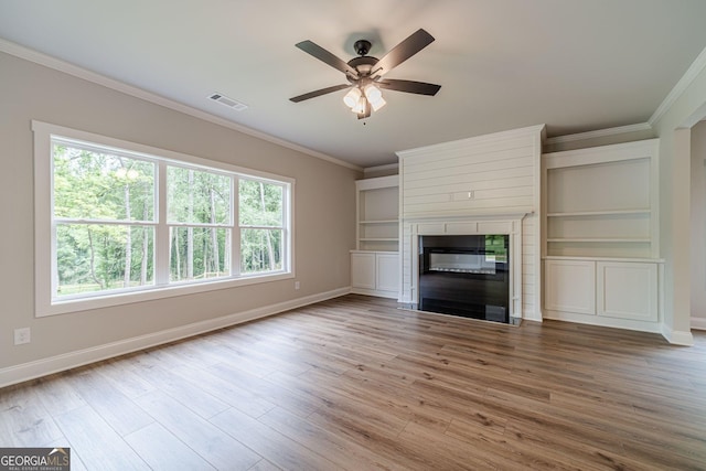 1482 Alcovy Station Rd, Covington, GA 30014 - unfurnished living room featuring ornamental molding, baseboards, a ceiling fan, a fireplace with flush hearth, and wood finished floors
