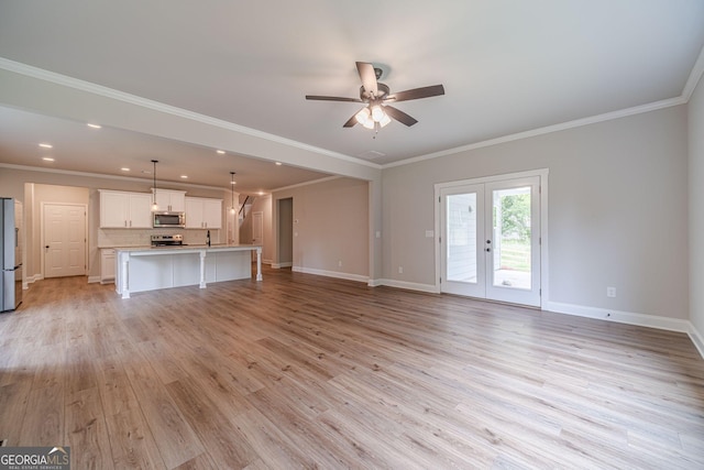 1482 Alcovy Station Rd, Covington, GA 30014 - unfurnished living room with light wood finished floors, baseboards, ceiling fan, recessed lighting, and french doors