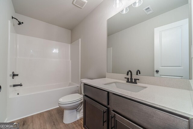 1482 Alcovy Station Rd, Covington, GA 30014 - full bathroom with wood finished floors, toilet, vanity, and bathtub / shower combination