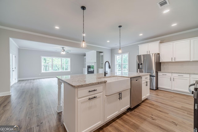 1482 Alcovy Station Rd, Covington, GA 30014 - kitchen with appliances with stainless steel finishes, a sink, open floor plan, a ceiling fan, and ornamental molding